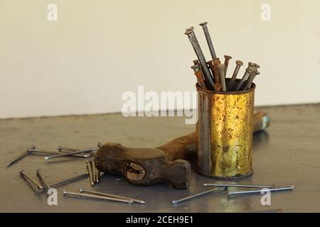 Vintage hammer with nails on metallic background with copy space. Carpenter's outfit Stock Photo