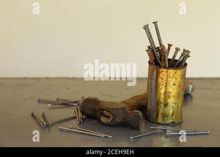 Vintage hammer with nails on metallic background with copy space. Carpenter's tools Stock Photo