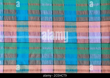 Bright fabric in a multi-colored cage. Checkered cotton fabric as background texture. Stock Photo