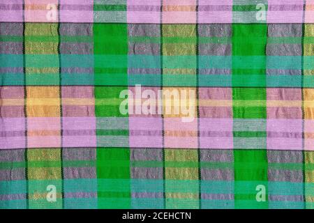 Bright fabric in a multi-colored cage. Checkered cotton fabric as background texture. Stock Photo