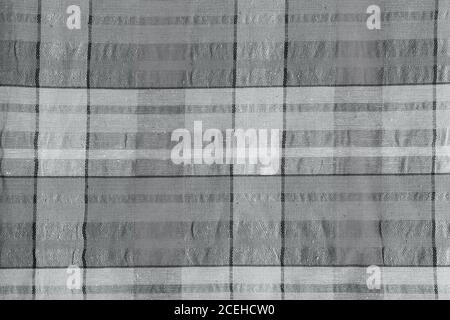 Grey fabric in a cage. Checkered gray cotton fabric as background texture. Stock Photo