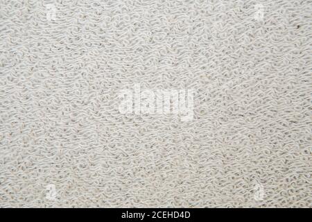 Macro shot of a terrycloth texture background. white Textile floor covering. Grey Knotted-pile carpet Stock Photo