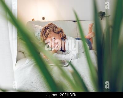 boy using tablet on sofa Stock Photo