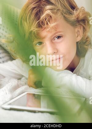 boy using tablet on sofa Stock Photo