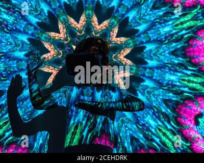 Bright projection on excited boy in VR headset Stock Photo