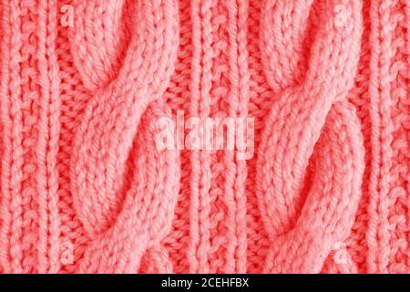 Sweater or scarf texture large knitting. Knitted jersey background with a relief pattern. Braids in knitting. Wool hand-knitted or machine knitting pa Stock Photo