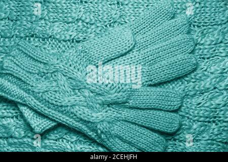 Wool sweater or scarf and gloves texture close up. Knitted jersey background with a relief pattern. Braids in machine knitting pattern. Wool hand-knit Stock Photo