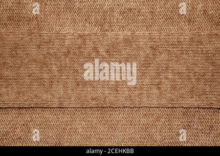 Wool sweater texture close up. Knitted jersey background with a relief pattern. Braids in machine knitting pattern Stock Photo
