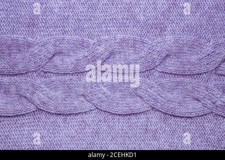 Wool sweater texture close up. Knitted jersey background with a relief pattern. Braids in machine knitting pattern Stock Photo