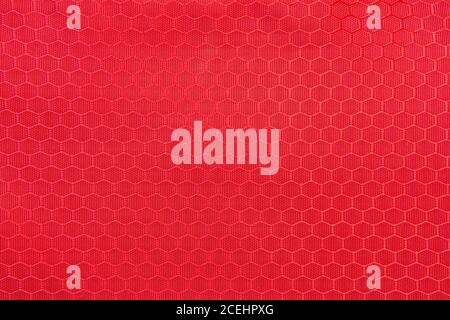 red honeycomb background texture. Texture background of polyester fabric. Plastic weave fabric pattern Stock Photo