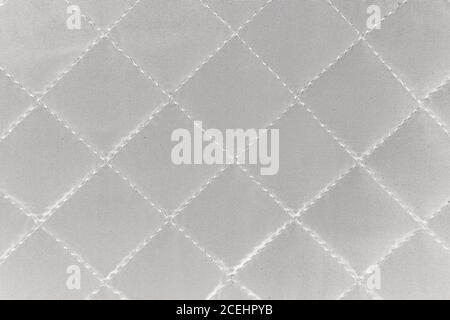 Cloth in rhombus. Quilted synthetic fabric texture background. Stock Photo