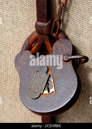 Antique key lock on rusted iron gate with chain Stock Photo