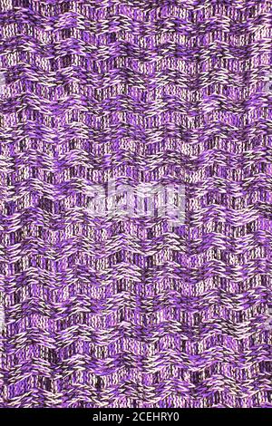 Wool scarf or sweater texture close up. Ultra Violet Knitted jersey background with a relief pattern. Braids in machine knitting pattern Stock Photo