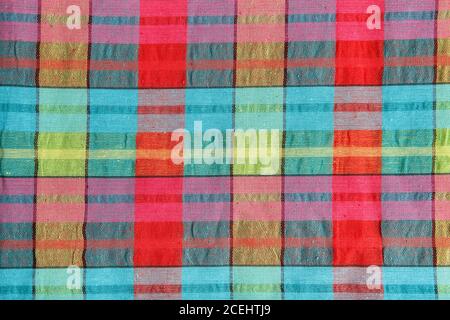 Bright fabric in a multi-colored cage. Checkered cotton fabric as background texture. Stock Photo