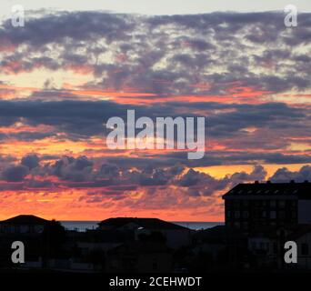 Sunset with strong colours over a coastal urban scene Santander Cantabria Spain Stock Photo