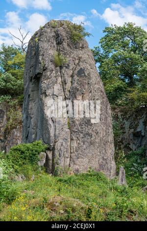 Rock pillar in front of the rock face at Stenzelberg against the blue sky. Stock Photo