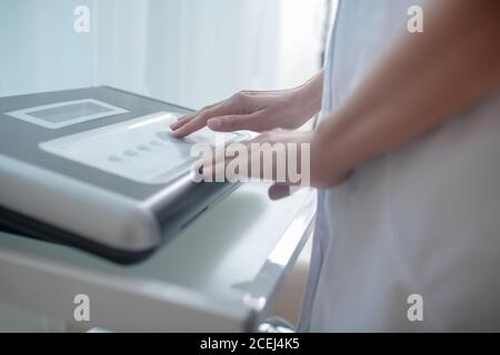 Close up picture of medical equipment and human hands touching it Stock Photo