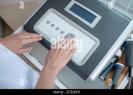 Close up picture of medical equipment and human hands pressing the button Stock Photo