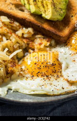 Homemade Fried Shredded Hashbrowns and Eggs for Breakfast Stock Photo