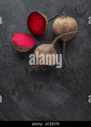 Beetroot cut in half on dark table. Overhead shotm with copy space. Stock Photo