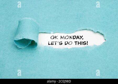 Motivational quote OK Monday, Let's Do This appearing behind torn blue paper. Monday motivation concept. Stock Photo