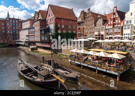 The old town of Lüneburg, Stintmarkt area at the river Ilmenau, historic harbor district, many restaurants, pubs, cafés, Lower Saxony, Germany, Stock Photo