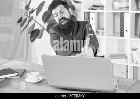 Lagging system. Hate office routine. Man bearded crush computer. Software license agreement. Destroy laptop. Hateful job. Bad computer. Slow internet connection. Outdated software. Computer lag. Stock Photo