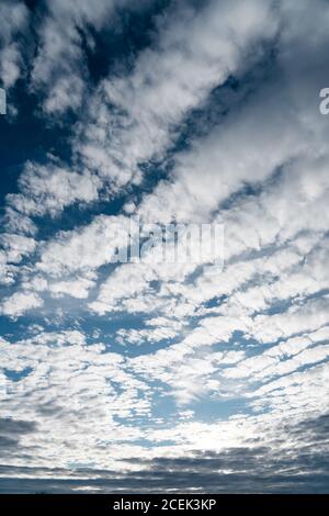 From below shot of soft white clouds floating on bright blue sky in Navarre, Spain Stock Photo