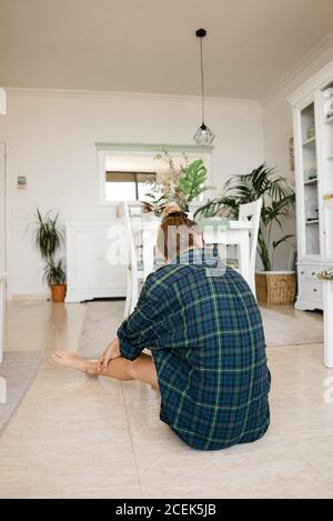 Beautiful woman sitting on floor Stock Photo - Alamy