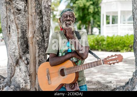 Jamaican man playing guitar Stock Photo