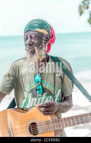 Jamaican man playing guitar Stock Photo