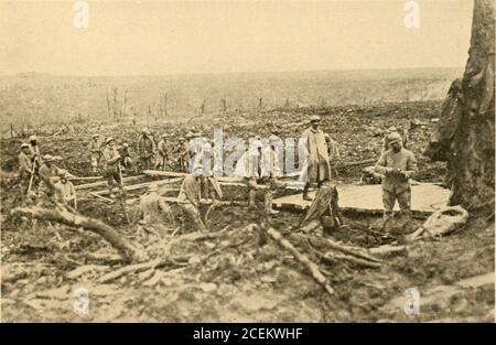 . The warfare of to-day. * ■ * Region of the Mort-Homme near erdun: a conquered German trench. Near Moulin de Laffaux, battle of the Aisne (1917) • Engineers constructing a route AFTER AX ADVANCE HOW TO ACHIEVE VICTORY The pursuit is characterized by a special tac-tical use of the different arms, infantry, artil-lery, aviation, engineers, and especially cavalry.Moreover, the march formations are not alwaysthe same throughout each arm. The troopsform in column whenever possible, instead ofdeploying in line, as the first-named formationis more suitable to advance. They have specialmarching zone Stock Photo