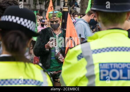 London, UK. 1st September, 2020. Metropolitan Police officers monitor climate activists from Extinction Rebellion occupying roads around Parliament Square during a Back The Bill rally. Extinction Rebellion activists are attending a series of September Rebellion protests around the UK to call on politicians to back the Climate and Ecological Emergency Bill (CEE Bill) which requires, among other measures, a serious plan to deal with the UK’s share of emissions and to halt critical rises in global temperatures and for ordinary people to be involved in future environmental planning by means of a C Stock Photo