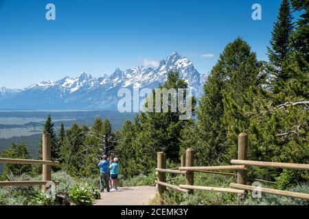 Wyoming, USA - June 26, 2020: Senior citizen tourists enjoy taking photos on top of Signal Mountain Overlook in Grand Teton National Park Stock Photo