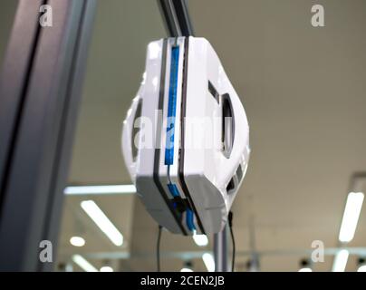 Voronezh, Russia - December 22, 2019: Window cleaning robot hanging on a glass panel Stock Photo
