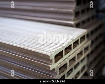 Polymer decking board stacked in a building materials warehouse Stock Photo