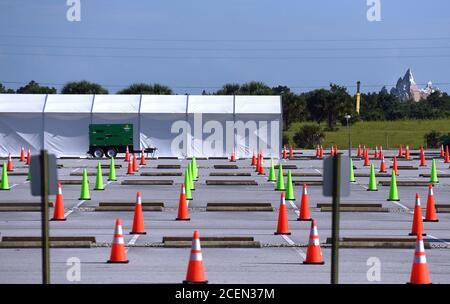 Kissimmee, United States. 01st Sep, 2020. Traffic cones are seen in a parking lot at a nearly empty COVID-19 testing site operated by the Florida Division of Emergency Management. As the number of coronavirus cases in Florida has dropped in recent weeks, so has the demand for testing. The Expedition Everest roller coaster at Walt Disney World's Animal Kingdom can be seen in the distance. Credit: SOPA Images Limited/Alamy Live News Stock Photo