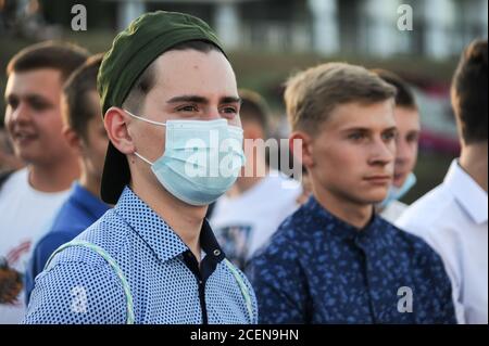 Tambov, Russia. 01st Sep, 2020. A student wearing a medical face mask and an other without medical masks seen during the celebration.A "Freshman day" was organized at the Music Square where a school line-up was held for students of grades 1 and 11 and students trained about compliance with all sanitary and epidemiological rules during the celebration. A new school year for schoolchildren and students has begun in Russia. Credit: SOPA Images Limited/Ģ����ý Live News Stock Photo