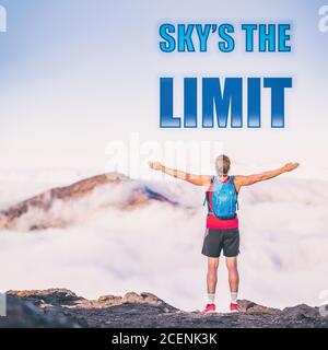 SKY'S THE LIMIT motivation quote on adventure lifestyle background written on sky copy space. Man with open arms in happiness and freedom active Stock Photo