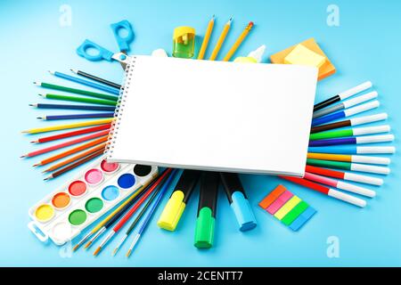 A set of school supplies for learning and creative development on a blue background. Stock Photo