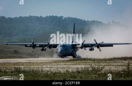 A U.S. Air Force Reserve aircrew from the 757th Airlift Squadron, Youngstown Air Reserve Station, Ohio, land a C-130H Hercules on a dirt landing zone during the distributed operations training event near Charleston, West Virginia, Aug. 25, 2020. The training event tested aircrew on their tactical combat airlift skills such as cargo airdrop, formation flights, and personnel delivery in a contested environment. There were a total of eight aircraft from various Reserve and Guard units supporting the training effort, enabling strategic depth and readiness for the force. (U.S. Air Force Reserve pho Stock Photo