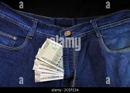 Ladies jeans with money. Close up view of pant zip with money. Blue Jeans with money. woman denim blue jeans with money. Satisfaction, adult. Stock Photo