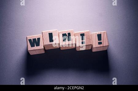 Win Word Written on Wooden Cubes Stock Photo