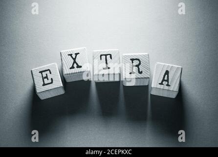Extra Word Written on Wooden Cubes Stock Photo