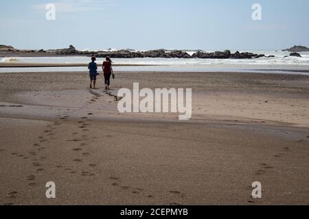 Caucasian couple leaving footprints on beach Stock Photo - Alamy