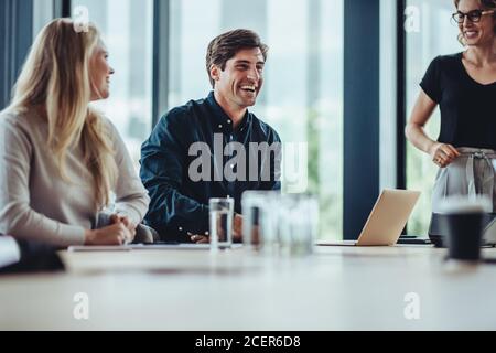 businessman smiling during a meeting. business people smiling after a productive meeting in a conference toom. Stock Photo
