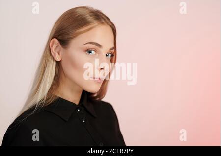 Portrait of young caucasian woman on pink studio background Stock Photo