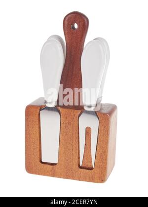 Set of stainless steel cheese cutlery, with white handles and wooden block, isolated on white background Stock Photo