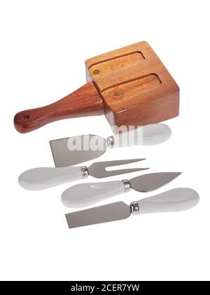 Set of stainless steel cheese cutlery, with white handles and wooden block, isolated on white background Stock Photo