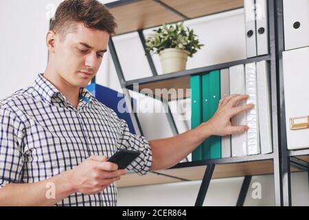 Businessman searching for folder Stock Photo